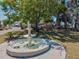 Picturesque fountain with an angelic statue centerpiece surrounded by trees with waterfront homes in the background at 7 Braden Castle Dr, Bradenton, FL 34208