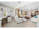Bright living room featuring neutral tones, stylish furniture, and large windows with lots of light at 7 Braden Castle Dr, Bradenton, FL 34208