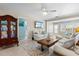 Living room features neutral decor, white couches, tv, and a vintage-style coffee table with a rug at 7 Braden Castle Dr, Bradenton, FL 34208