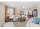 Inviting living room featuring neutral tones, stylish furniture, and a built-in bookshelf at 7 Braden Castle Dr, Bradenton, FL 34208