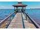 Inviting pier leads to a covered gazebo with scenic views, providing a tranquil spot amidst serene waters at 7 Braden Castle Dr, Bradenton, FL 34208
