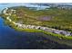 Breathtaking aerial view of waterfront homes along a coastline with lush greenery and serene water features at 71 Tidy Island Blvd, Bradenton, FL 34210