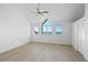 Bright bedroom featuring hardwood floors, large windows with water views, and a ceiling fan at 71 Tidy Island Blvd, Bradenton, FL 34210