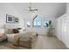 Bright main bedroom with vaulted ceiling, large windows with water views, and minimalist decor at 71 Tidy Island Blvd, Bradenton, FL 34210