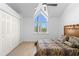 Bright bedroom with a ceiling fan, large window, plush bed, and ample closet space at 71 Tidy Island Blvd, Bradenton, FL 34210