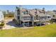 Coastal townhome features rear screened in porch, deck, under house parking with waterfront views at 71 Tidy Island Blvd, Bradenton, FL 34210