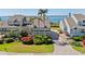 Waterfront townhome features lush landscaping, brick paver driveway, and stunning ocean views in a desirable coastal community at 71 Tidy Island Blvd, Bradenton, FL 34210