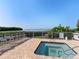 Community hot tub featuring a scenic bay view, lounge chairs, and a brick surface at 71 Tidy Island Blvd, Bradenton, FL 34210