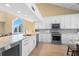Well-appointed kitchen boasts ample cabinet space, stainless appliances, granite counters and a view at 71 Tidy Island Blvd, Bradenton, FL 34210