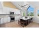 Bright kitchen featuring white cabinetry, stainless steel appliances, island with seating, and large windows at 71 Tidy Island Blvd, Bradenton, FL 34210