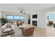 Comfortable living room with fireplace, waterfront views, and access to balcony at 71 Tidy Island Blvd, Bradenton, FL 34210