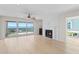 Bright living room with fireplace, access to balcony with waterfront view, and ceiling fan at 71 Tidy Island Blvd, Bradenton, FL 34210