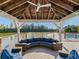 Open air outdoor patio with ample seating, a scenic waterfront view, and a covered overhead at 71 Tidy Island Blvd, Bradenton, FL 34210