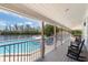 A relaxing view of the community pool from the porch, surrounded by lush greenery and tranquil water views at 71 Tidy Island Blvd, Bradenton, FL 34210