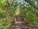 Scenic boardwalk path surrounded by lush greenery, rope railings, and natural scenery at 71 Tidy Island Blvd, Bradenton, FL 34210
