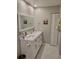 Modern bathroom with a double sink vanity, a large mirror, and shaker cabinets for ample storage at 7520 4Th W Ave # 1, Bradenton, FL 34209