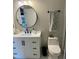 Bright bathroom features a white vanity with modern fixtures and round mirror at 7520 4Th W Ave # 1, Bradenton, FL 34209