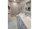 Stylish bathroom with a single sink vanity and river rock shower featuring a glass enclosure at 7520 4Th W Ave # 1, Bradenton, FL 34209