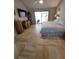 Spacious bedroom with tile floors, a ceiling fan, a sliding glass door to the patio, and classic furniture at 7520 4Th W Ave # 1, Bradenton, FL 34209