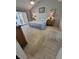 Serene bedroom with tile floors, a ceiling fan, traditional furniture, and access to the outdoor patio at 7520 4Th W Ave # 1, Bradenton, FL 34209