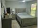 Comfortable bedroom featuring neutral paint, ceiling fan, and ample closet space at 7520 4Th W Ave # 1, Bradenton, FL 34209