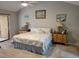 Bright bedroom with beach-themed decor, a ceiling fan, classic furnishings, and access to outdoor patio at 7520 4Th W Ave # 1, Bradenton, FL 34209