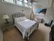 Cozy bedroom featuring a black iron bed frame and plenty of natural light from the tall windows at 7520 4Th W Ave # 1, Bradenton, FL 34209