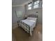 Cozy bedroom featuring a metal frame bed, neutral walls, and bright, natural light at 7520 4Th W Ave # 1, Bradenton, FL 34209