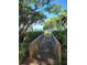 Wooden deck with a waterfront view framed by trees and lush foliage at 7520 4Th W Ave # 1, Bradenton, FL 34209