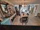 Open-concept dining area featuring a spiral staircase, wood-look tile flooring, and views of the living area at 7520 4Th W Ave # 1, Bradenton, FL 34209
