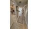 Hallway with an area for bar stools, tile flooring, and a view to other rooms at 7520 4Th W Ave # 1, Bradenton, FL 34209