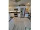 Spacious kitchen with stainless steel refrigerator, white cabinets and stainless steel appliances at 7520 4Th W Ave # 1, Bradenton, FL 34209