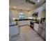 Bright kitchen featuring white cabinets, stainless steel appliances, and modern lighting at 7520 4Th W Ave # 1, Bradenton, FL 34209