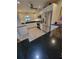 Bright kitchen with white cabinets, stainless steel appliances and black counter tops at 7520 4Th W Ave # 1, Bradenton, FL 34209