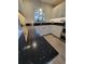 Kitchen sink features black countertops, window, and white cabinets at 7520 4Th W Ave # 1, Bradenton, FL 34209