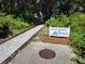 Landscaped path with gravel leads to private wooded property with 'no trespassing' sign at 7520 4Th W Ave # 1, Bradenton, FL 34209