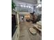 Open living room with a spiral staircase leading to a loft and views of the kitchen and front entry at 7520 4Th W Ave # 1, Bradenton, FL 34209