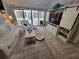 Cozy living room with neutral décor, a sliding glass door to the patio, and a custom entertainment center at 7520 4Th W Ave # 1, Bradenton, FL 34209
