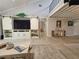 Bright living area with vaulted ceilings, a sliding glass door, and a custom entertainment center at 7520 4Th W Ave # 1, Bradenton, FL 34209