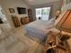 Spacious main bedroom featuring stylish decor, tiled floors, and sliding glass doors to the patio at 7520 4Th W Ave # 1, Bradenton, FL 34209