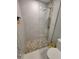 Updated shower featuring river rock flooring, a glass enclosure, and sleek tiling for a spa-like feel at 7520 4Th W Ave # 1, Bradenton, FL 34209