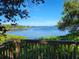 Waterfront view of a serene bay with a boat dock visible from a wooden deck at 7520 4Th W Ave # 1, Bradenton, FL 34209