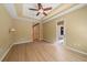 Well-lit bedroom boasts hardwood floors, a ceiling fan, and neutral walls at 7618 Broomsedge Ct, Lakewood Ranch, FL 34202
