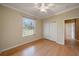 Bright bedroom with hardwood floors, window, ceiling fan and closet space for ample storage at 7618 Broomsedge Ct, Lakewood Ranch, FL 34202