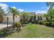 Beautiful single-story home with a three-car garage and lush tropical landscaping at 7618 Broomsedge Ct, Lakewood Ranch, FL 34202