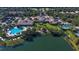 Stunning aerial view of the clubhouse, pool, and surrounding lake, showcasing the community's amenities at 7664 Camminare Dr, Sarasota, FL 34238