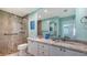 Updated bathroom featuring a double vanity, granite counters and a glass enclosed shower at 7664 Camminare Dr, Sarasota, FL 34238