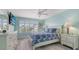 Light-filled bedroom with white furniture, coastal decor, and plantation shutters at 7664 Camminare Dr, Sarasota, FL 34238