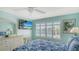 Comfortable bedroom with a view, stylish furnishings, and bright natural light at 7664 Camminare Dr, Sarasota, FL 34238