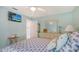 Bedroom featuring light walls, TV, ceiling fan and ensuite bathroom at 7664 Camminare Dr, Sarasota, FL 34238